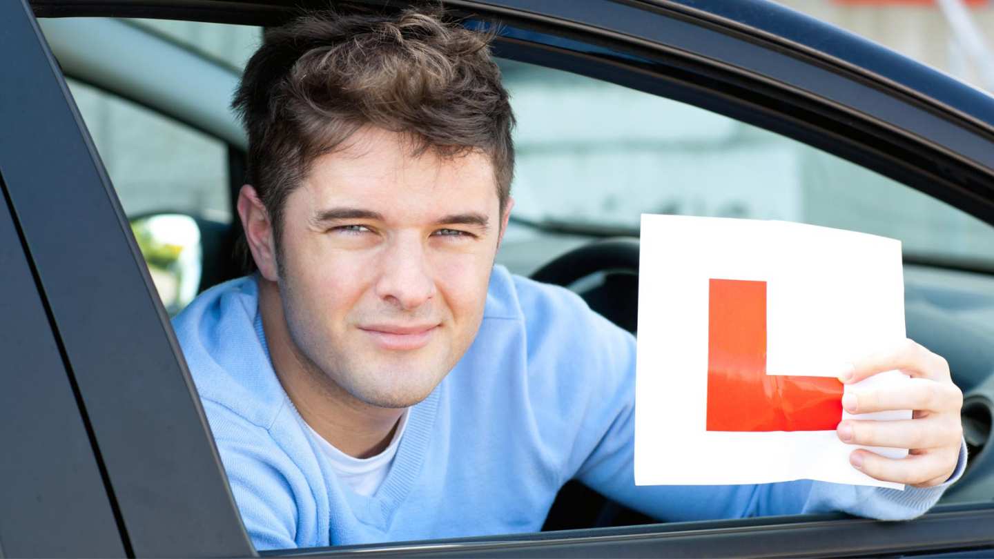 Student holding L plate